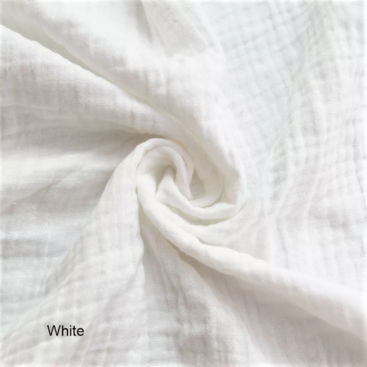 A close-up view of a white fabric, possibly cotton, with a crinkled texture.