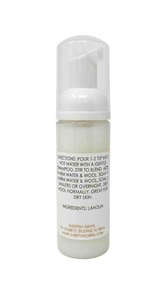 a bottle of a white liquid, likely a shampoo or conditioner, with a label that provides directions and ingredients.