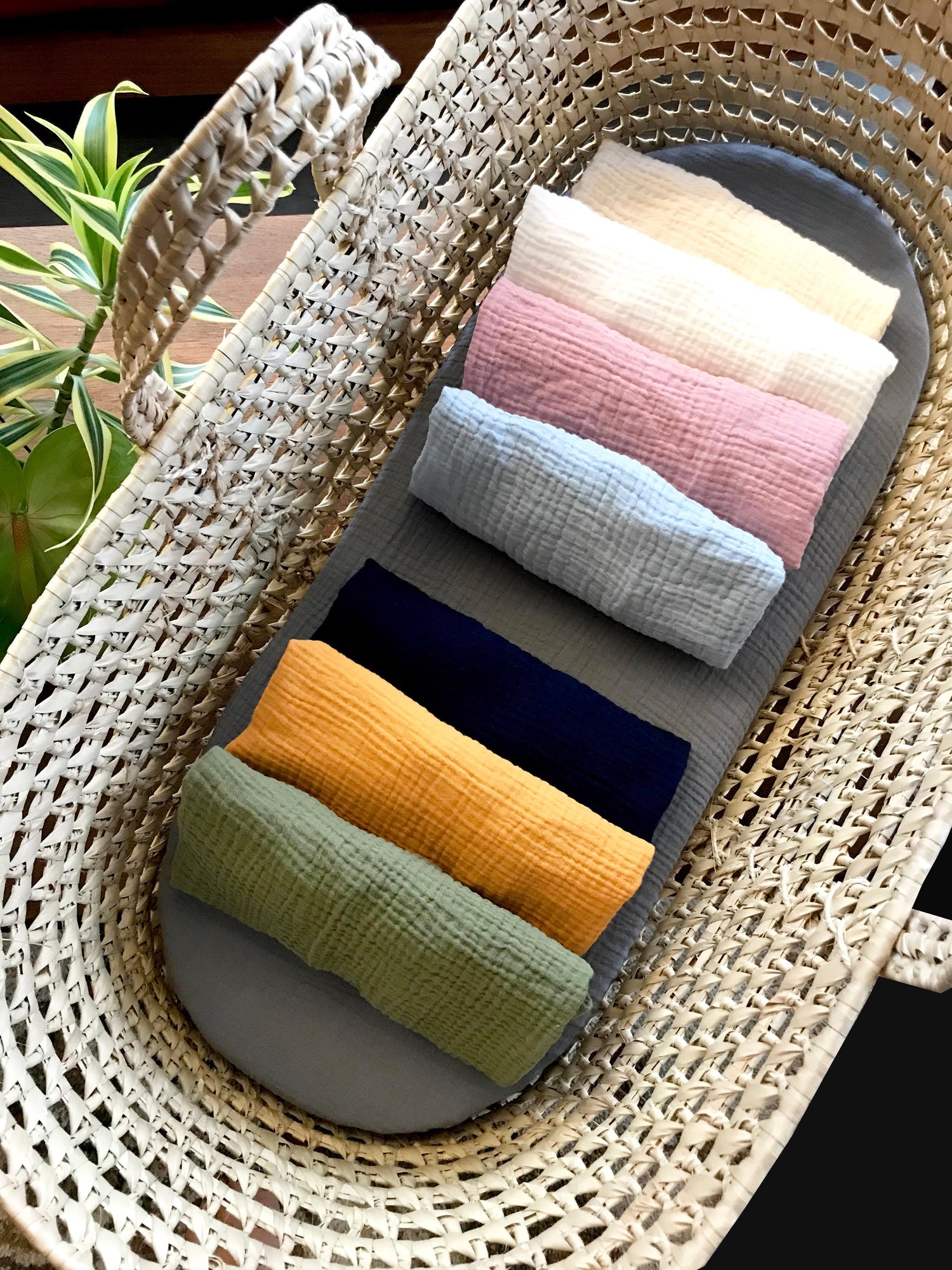 Custom size and shape fitted sheet for Moses basket, bassinet, cradle, crib. Sheet is shown rolled up with 7 different colors. Fitted sheets come in a variety of patterns and fabrics, including cotton, organic cotton, linen, minky dot and cotton prints.