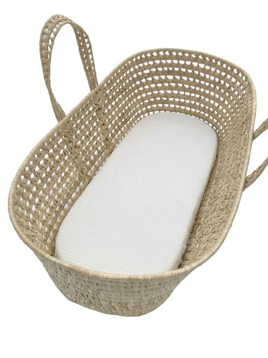A woven basket with a white mattress inside.